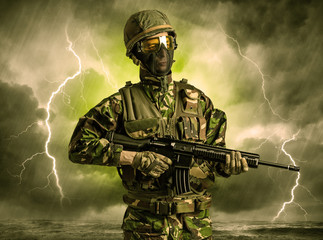 Armed soldier standing in rainy obscure weather
