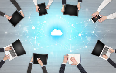 Group of people with devices in hands working in team on tablets, laptops with application concept

