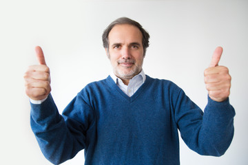 Smiling bearded mature man showing thumbs up. Positive Caucasian man gesturing thumbs up and looking at camera. Isolated on white. Motivation concept