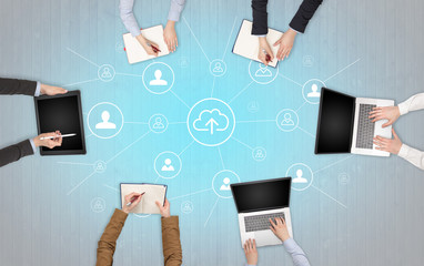 Group of people with devices in hands working in team on tablets, laptops with office, connection,...