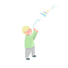 Cute little boy with flying kite isolated on white background. Blonde preschool boy happy smiling and playing with toy kite.