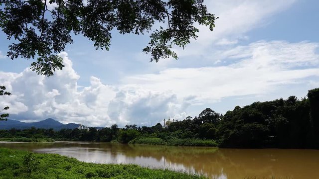 Timelapse of scenery and cloud at Sungai Perak with a view of public mosque, known as Ubudiah Mosque and Perak Royal Palace Istana Iskandariah in Kuala Kangsar Perak Malaysia. UNGRADED OUT