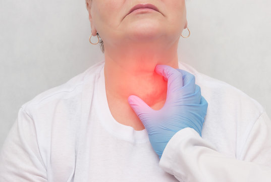 Doctor feels the thyroid gland in a patient of an adult woman, thyroid cancer, close-up, node