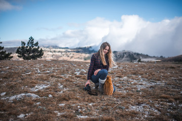 girl walks in the mountains with a cat