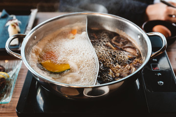 Hot and Boiling Shabu broth: Shoyu soup base and clear soup base in hot pot that ready for boiling...