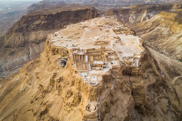 Masada fortress area Southern District of Israel Dead Sea area Southern District of Israel. Ancient Jewish fortress of the Roman Empire on top of a rock in the Judean desert, front view from the air