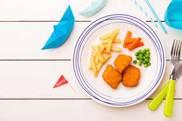 Kid's meal (dinner) - fish, chips, carrot and green peas