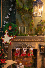 Christmas Atmosphere. Decorated fireplace. Star and candles. Spruce with gifts