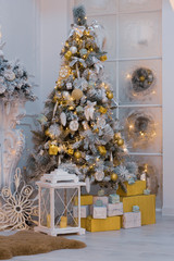 Christmas white spruce decorated with toys and gifts