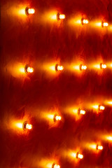 Copper-colored price with bulbs in a row