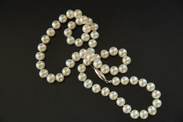 A pearl necklace for woman isolated on black background