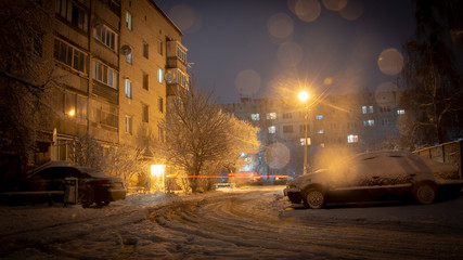 Fototapeta na wymiar Night winter landscape in the alley of city street
