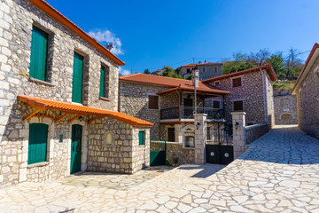 Street view of Zigovisti mountainous village in Arcadia, Peloponnese, Greece. Paved alleys with traditional stone houses