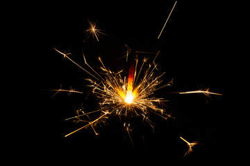 Glittering burning sparkler on Christmas Day and on New Year Day