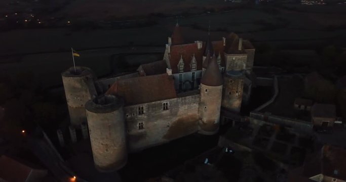 Night aerial view of impressive medieval castle of Chateau de Chateauneuf in valley of Canal de Bourgogne, France