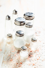 Iodized salt in salt shaker on white table
