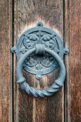 Fototapeta na wymiar Old iron-clad doors with rusty metal ring handles