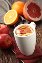 A cup of hot grapefruit with apple and orange tea