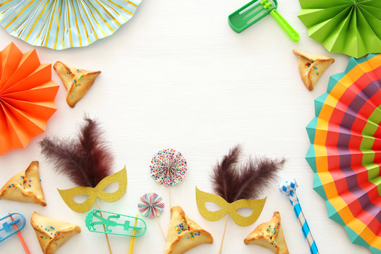 Purim celebration concept (jewish carnival holiday) over white wooden background. Top view - Image.
