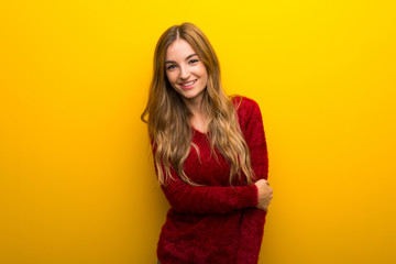Young girl on vibrant yellow background With happy expression