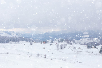 Fototapeta na wymiar Snowfall in winter mountains