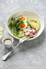 Healthy vegetable salad with avocado,egg and arugula. Plant based, clean eating, vegetarian concepts. 