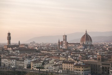 Fototapeta na wymiar Landscape of the city of Florence, Italy on a long-focus lens, view from the viewpoint of the cathedral Cattedrale di Santa Maria del Fiore in the evening time of the sunset.