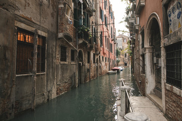 Cozy, calm, atmospheric place in Venice, Italy. The canal and the old architecture of the residential buildings of Venice. Another Venice.