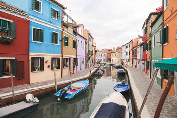Fototapeta na wymiar Beautiful landscape of Burano Island. Colored houses, canal and boats in Burano, Venice.