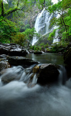 Naklejka na ściany i meble Beautiful great waterfall in tropical forest at Khlong Lan National park, Kamphaeng Phet, Thailand