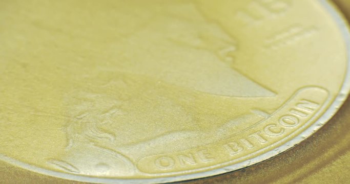 Crypto currency Gold Bitcoin - BTC - Bit Coin in gold paints. 4K. Macro.
