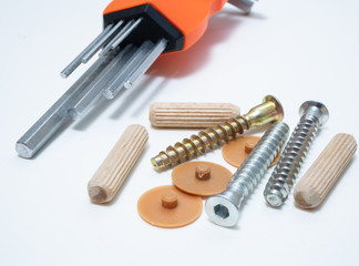 some tools and screws for diy home furniture assemble. key wrenches, wooden connectors