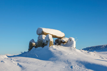 Ancient passage grave in a winter landscape