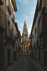 Fototapeta na wymiar Primate Cathedral of Saint Mary of the tower between the streets of Toledo, Spain