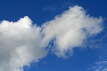 Naklejka na ściany i meble White clouds in the bright blue sky