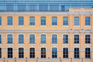 The facade of the old building in the winter under the snow