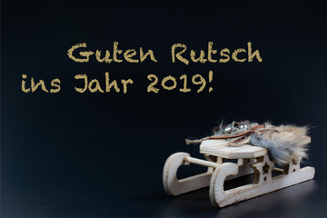 Guten Rutsch ins Jahr 2019 mit Element Schlitten auf schwarzem Hintergrund