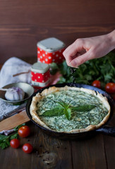 Green vegan pie with basil, ricotta ant tomatoes