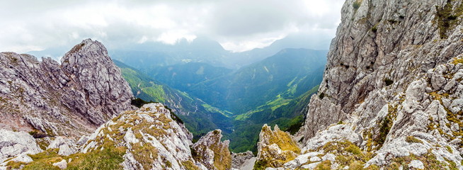 Rocks with cloudy sky behind on wide alley background, Peca, Slovenia