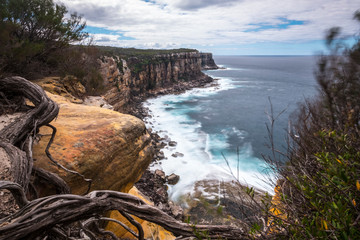 Long exposure waves and cliffs at head lookout. Manly walking trek. Australia