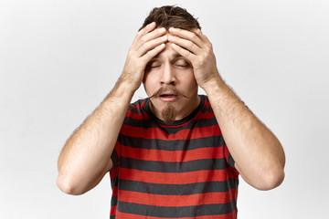Stress, problems and negative emotions concept. Picture of fashionable young unshaven man in...