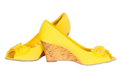 Women's fashion wedge shoes, isolated, white background. High-heeled shoes, fabric, yellow. A beautiful piece of clothing. Horizontal image, copy space, close-up, front view.