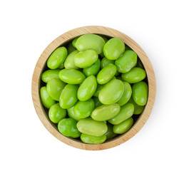 soy beans in wood bowl isolated on white background. top view