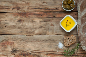  Bread with herbs and olive oil on the rustic background.