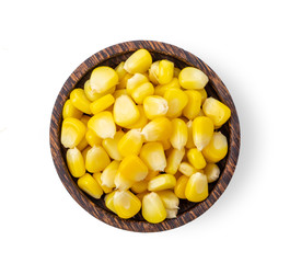 corn seeds in wood bowl isolated on white background. top view