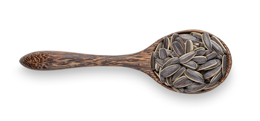 sunflower seeds in wood spoon isolated on white background. top view