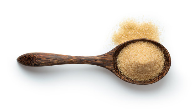 Brown Sugar In Wood Spoon Isolated On White Background. Top View