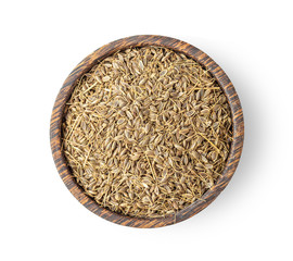dried caraway seeds in wood bowl isolated on white background. top view