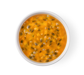 passion fruit in white bowl isolated on white background. top view