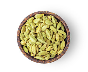 Top view of group of cardamom in wood bowl isolated on white background
